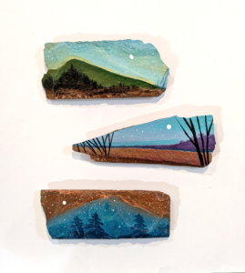 Three miniature slate shard landscapes, top piece in greens. Middle: blue sky copper lake with trees. Bottom: copper night sky and blue landscape with trees.
